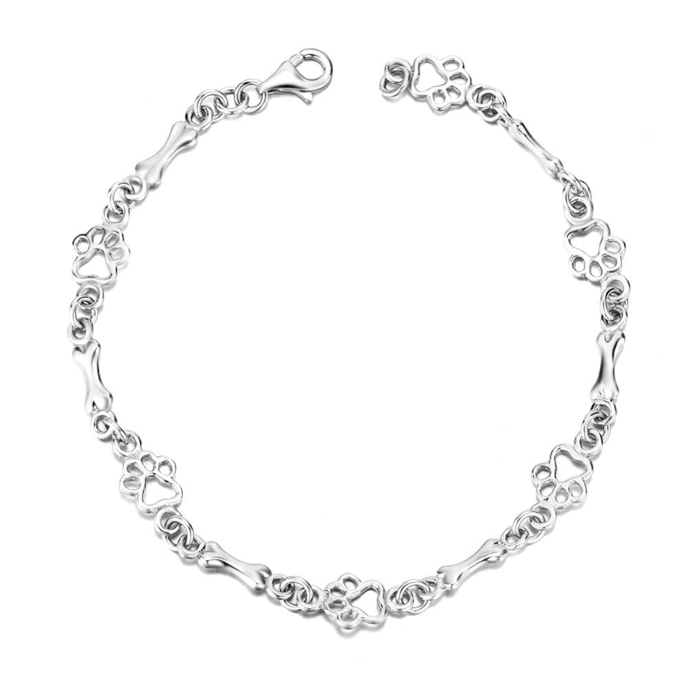 Bracelet en argent avec pendentif en forme de patte de chien et d'os